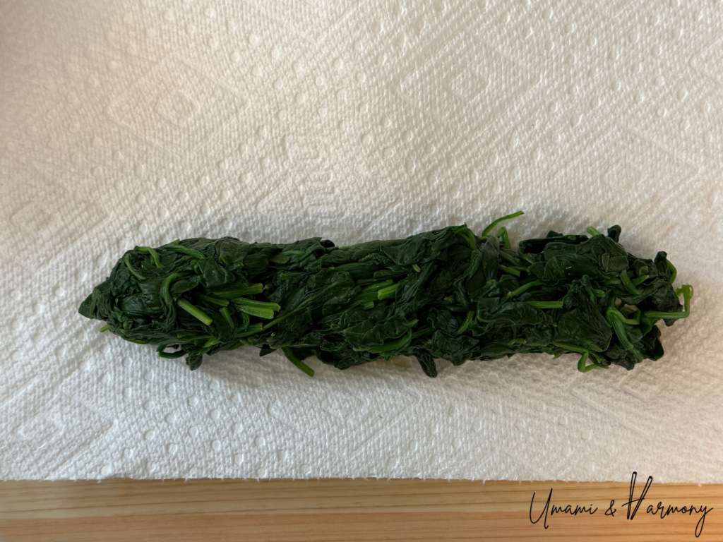 Blanched spinach placed on kitchen paper towels