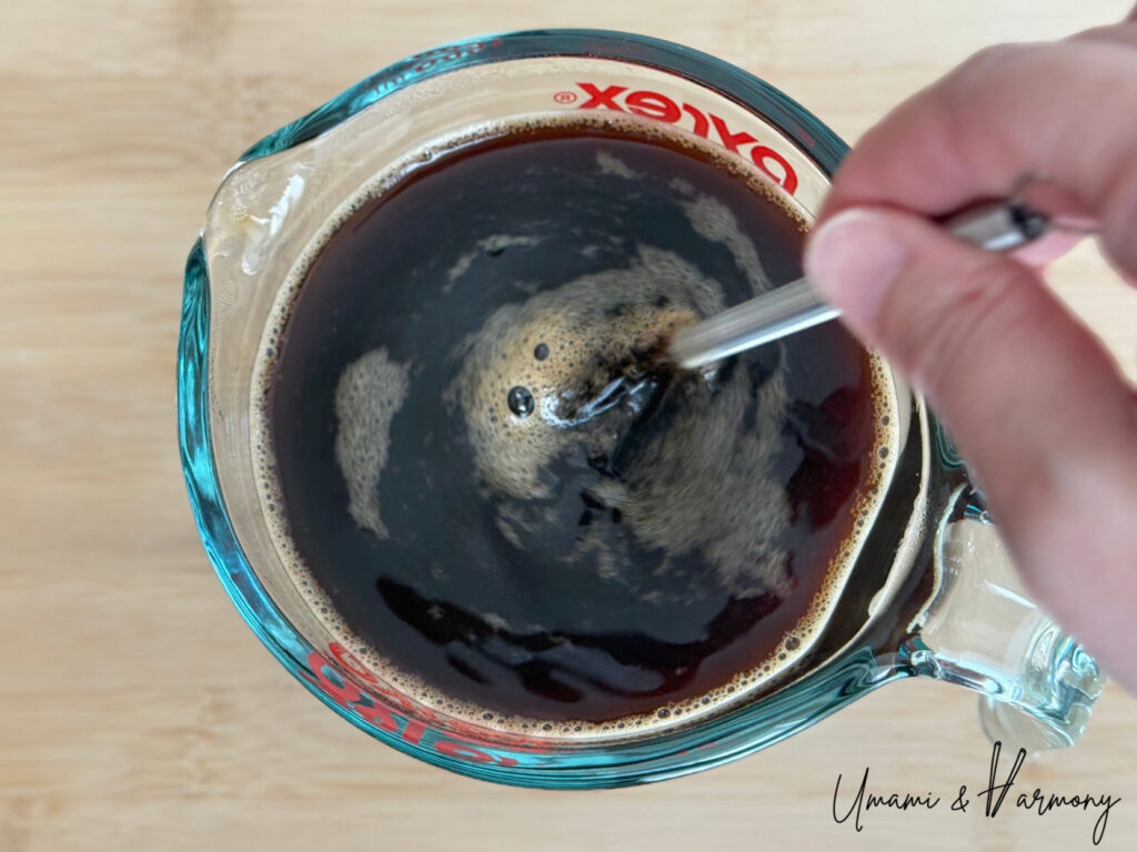 Coffee mixture being stirred until sugar is fully dissolved