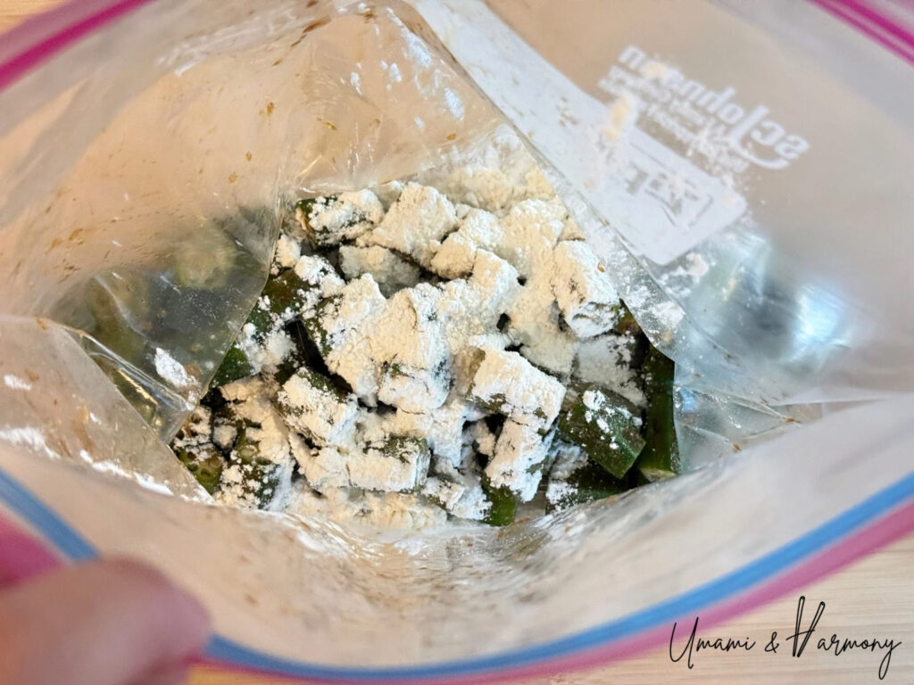 Flour and starch added to okra in a bag