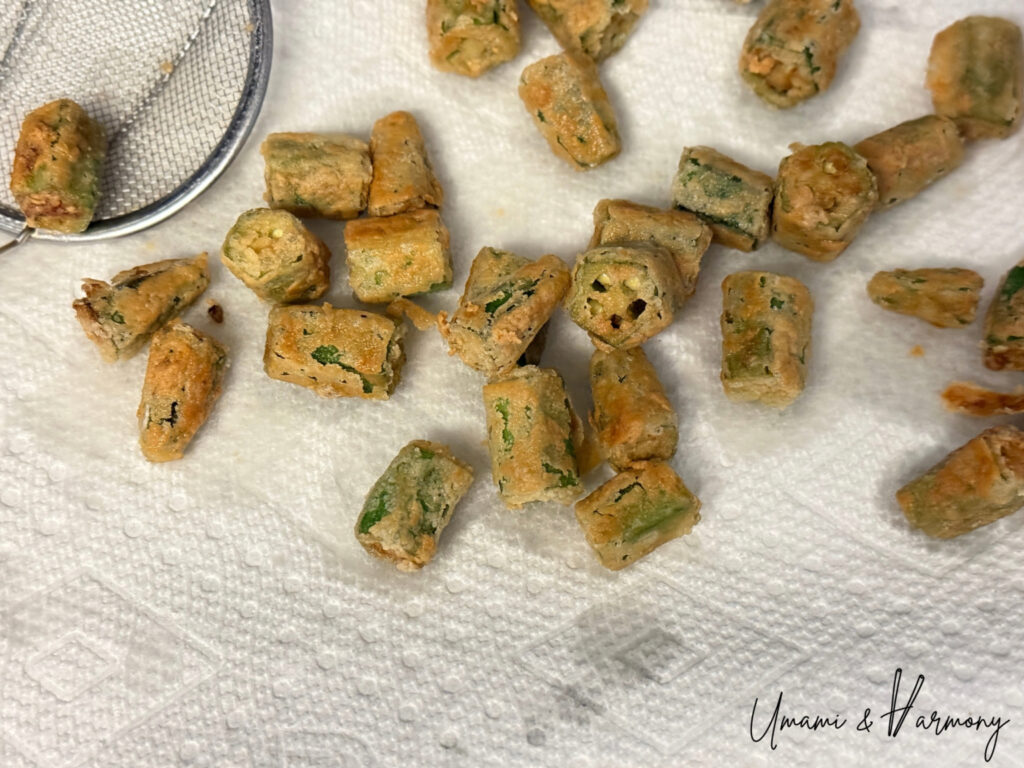 Fried okra draining excess oil on a paper towel 