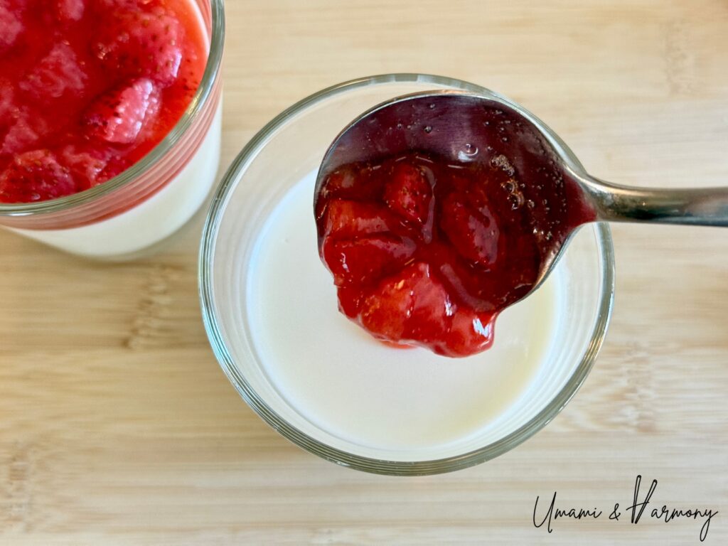 Strawberry sauce spooned over set panna cotta
