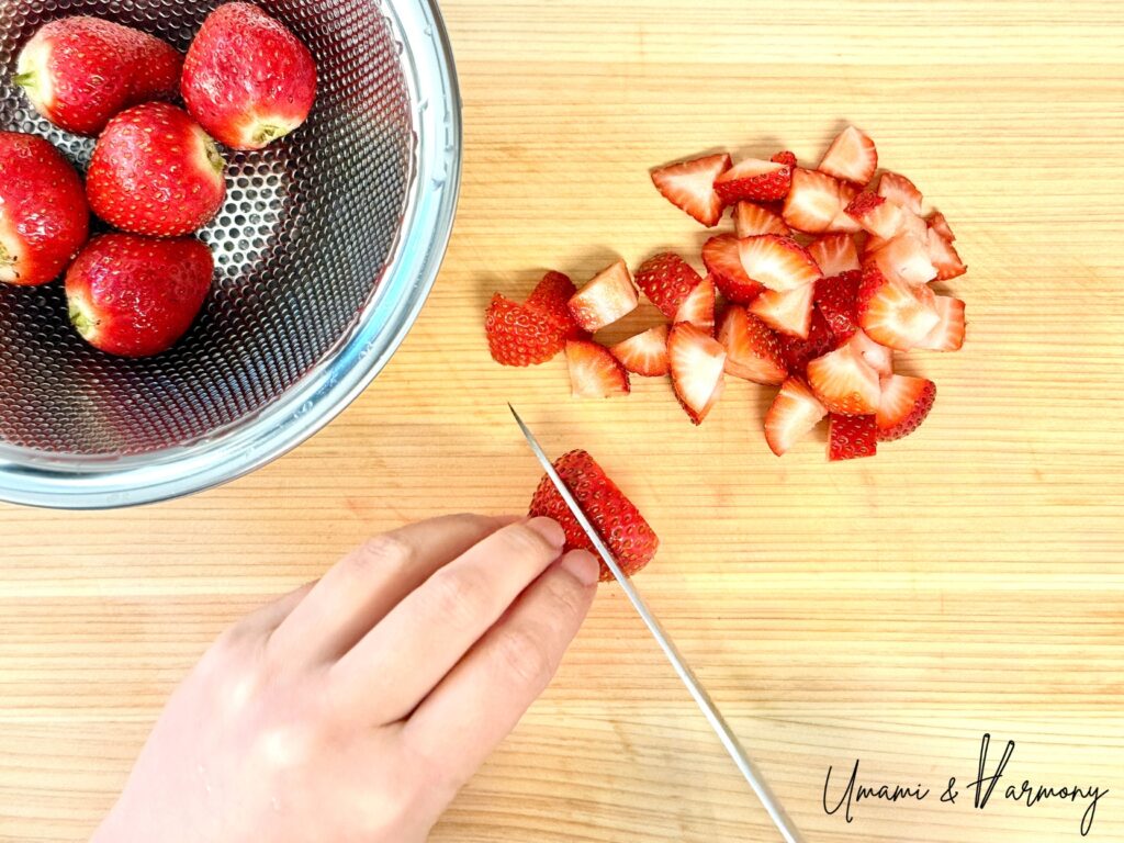 Fresh strawberries being chopped into small pieces
