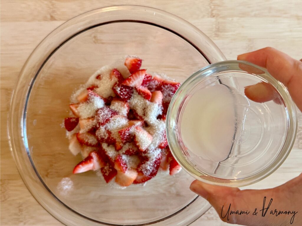 Lemon juice being added to chopped the strawberries 