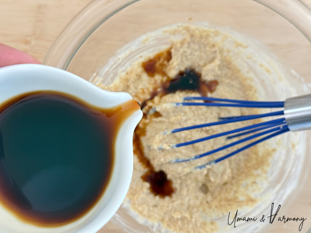 Soy sauce being added gradually to sesame dressing mixture
