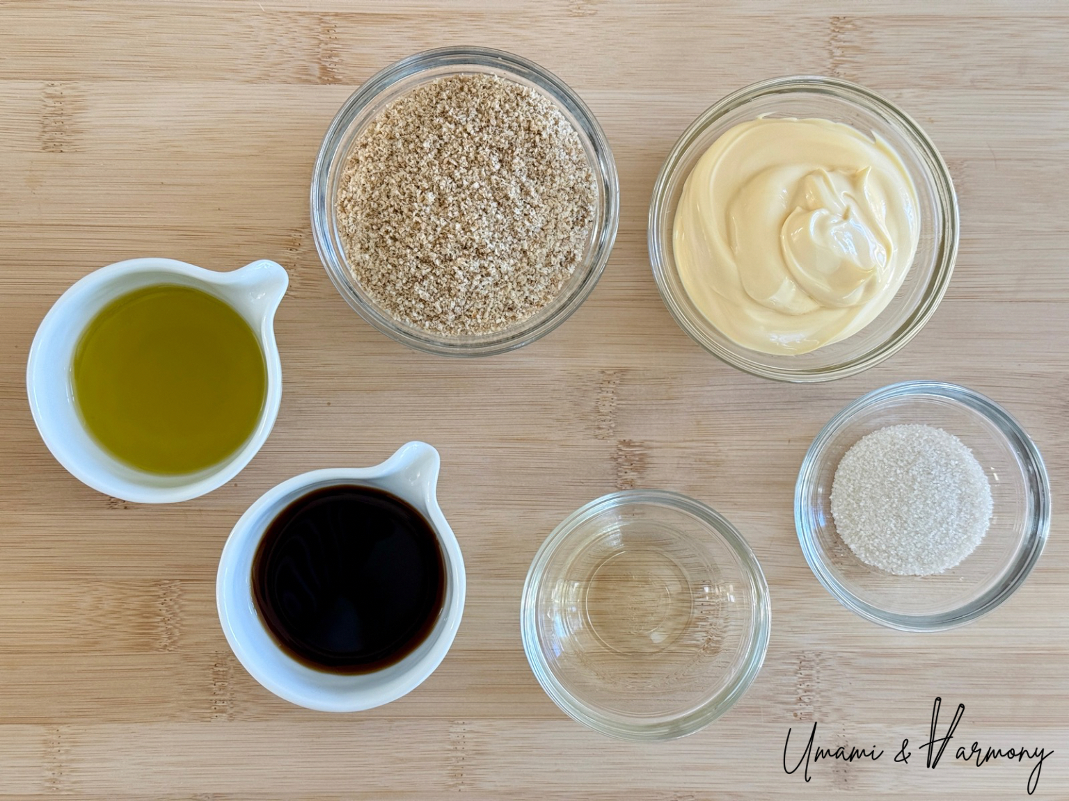 Ingredients for creamy sesame dressing including ground sesame, mayonnaise, sugar, soy sauce, rice vinegar, and oil