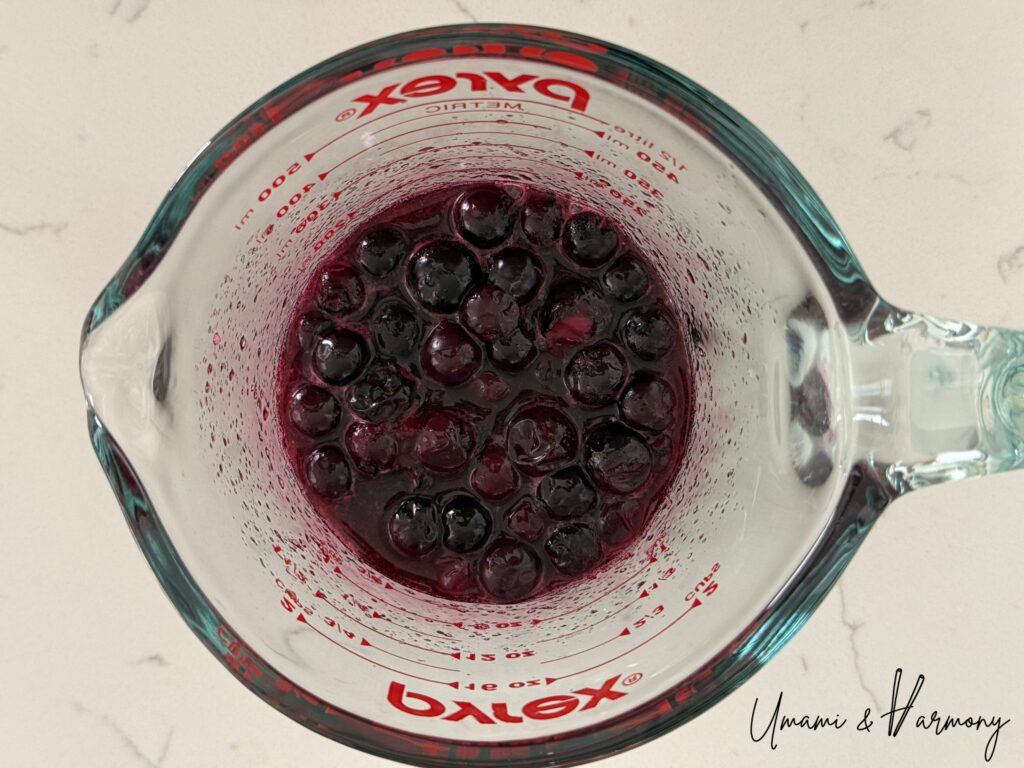 Cooked blueberry topping cooling in a bowl