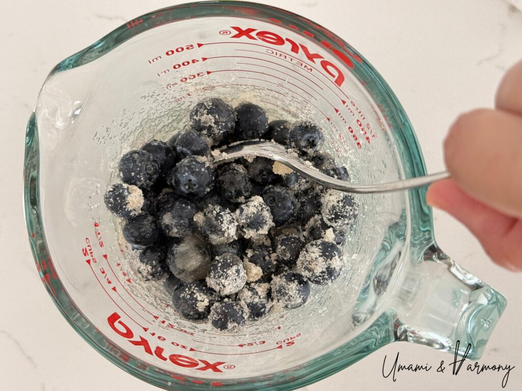 Stirring blueberry mixture with a spoon