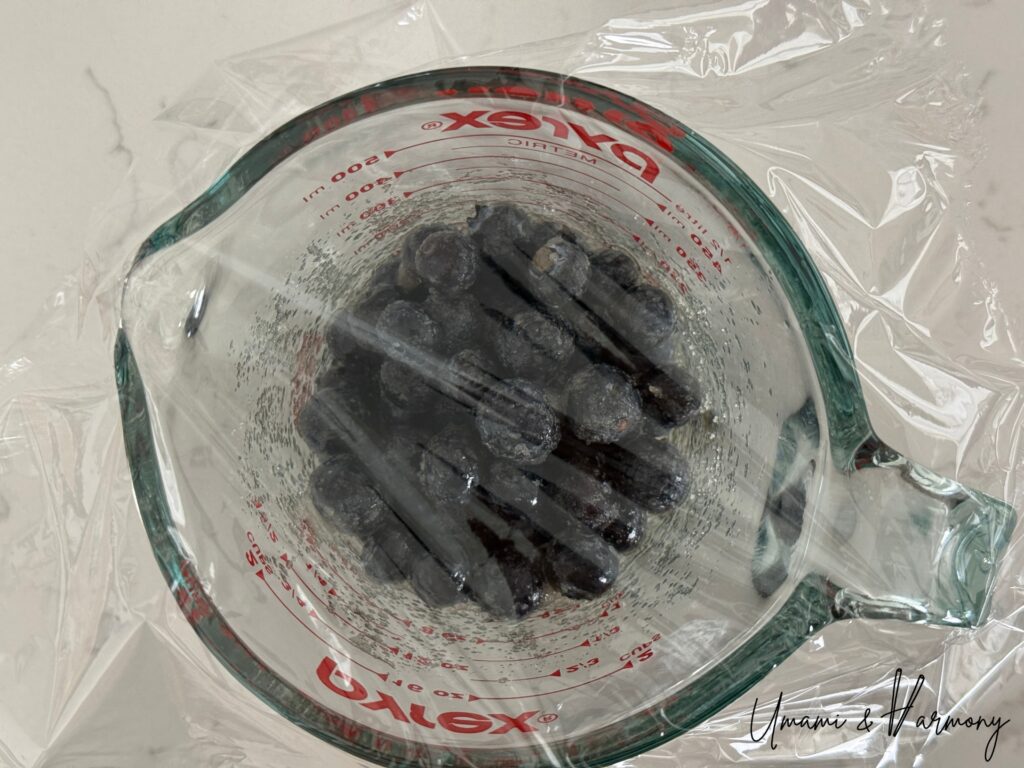 Blueberry mixture container covered with plastic wrap