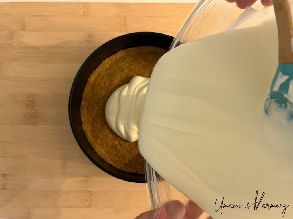 Cheesecake filling poured over graham cracker crust