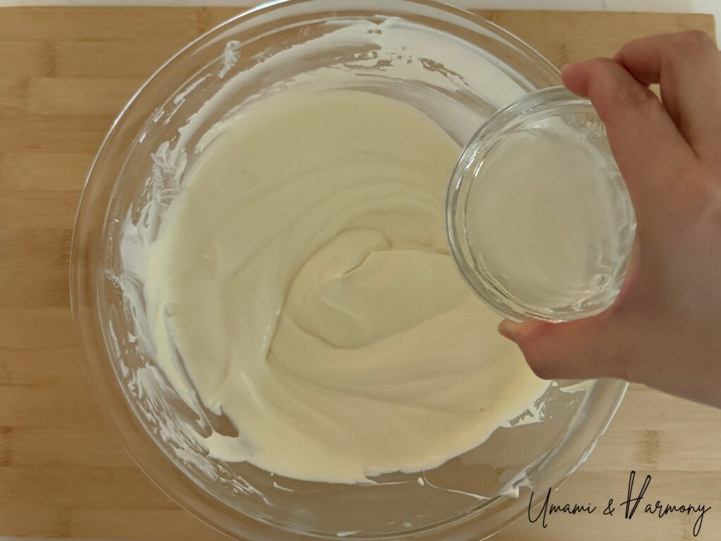 Melted gelatin being added to cheesecake filling