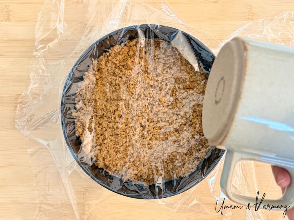 Compacting cheesecake crust with a cup