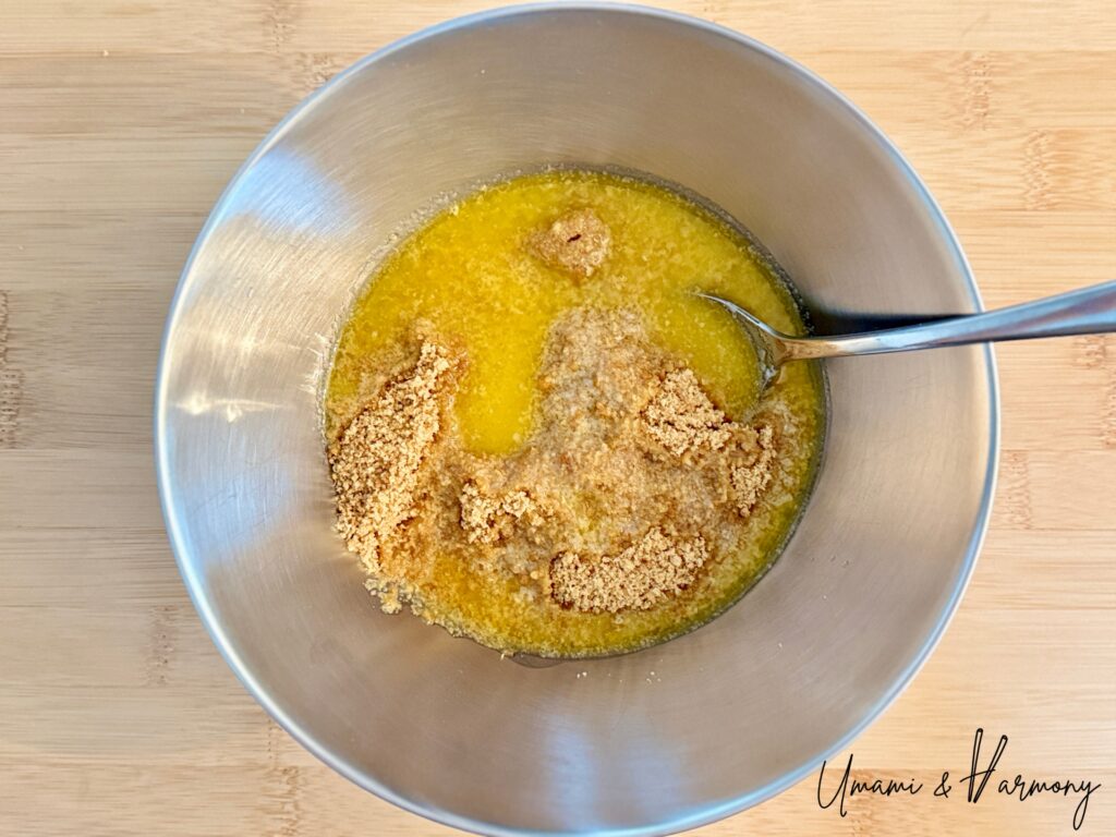 Melted butter being poured into graham cracker crumbs