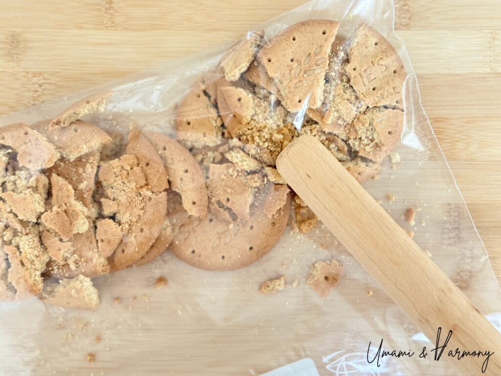 Crushing graham crackers with a rolling pin