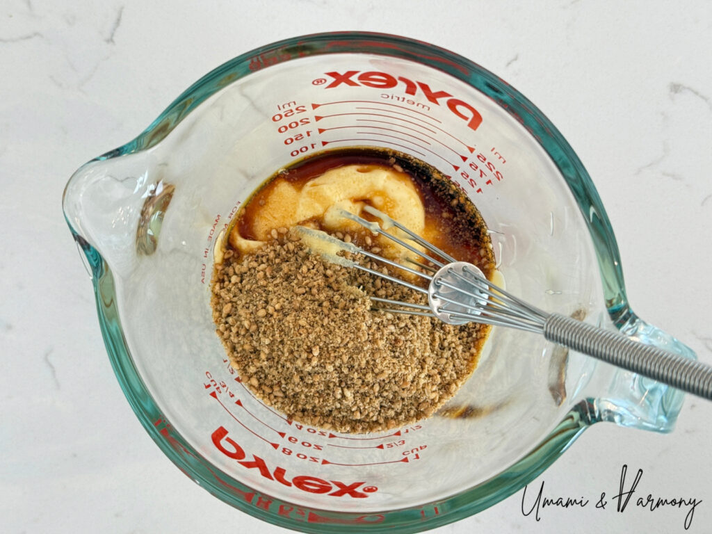 Japanese mayonnaise, sesame, soy sauce, and bonito flakes in a mixing bowl