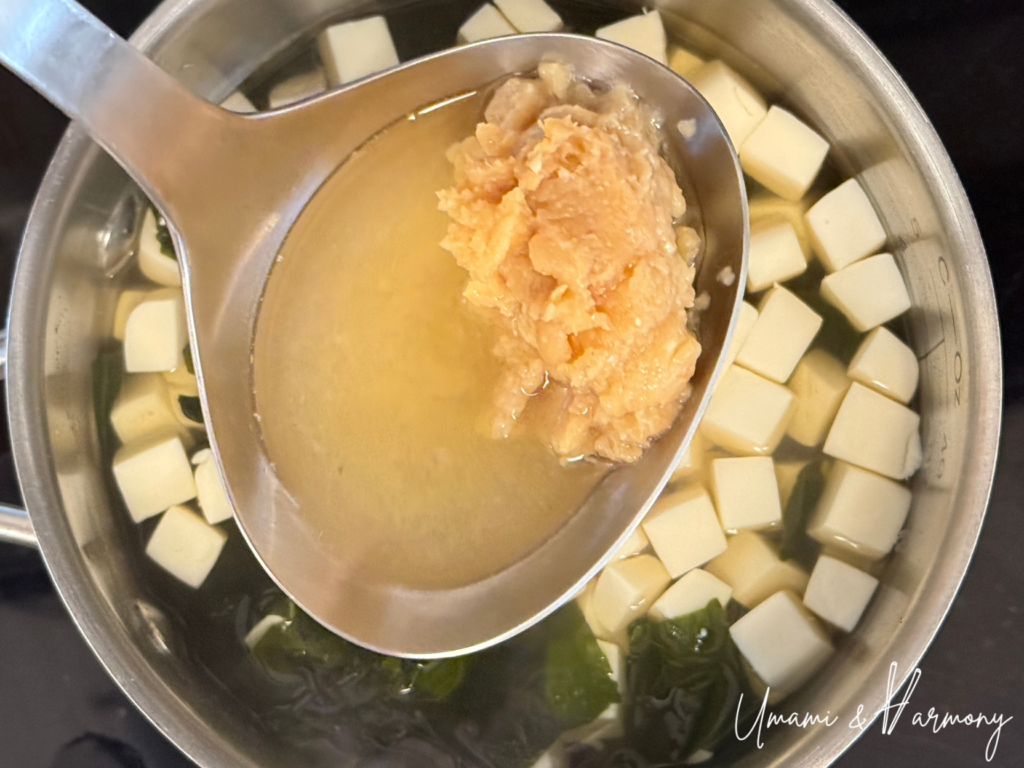 Miso paste being dissolved into hot dashi