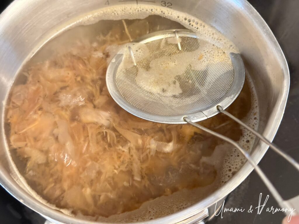 Foam being skimmed from bonito dashi