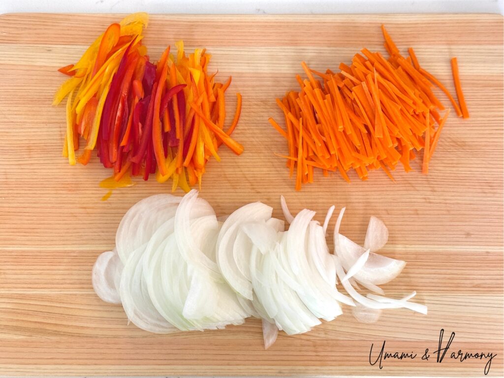 Carrot, onion, and mini bell peppers thinly sliced for Salmon Nanbanzuke